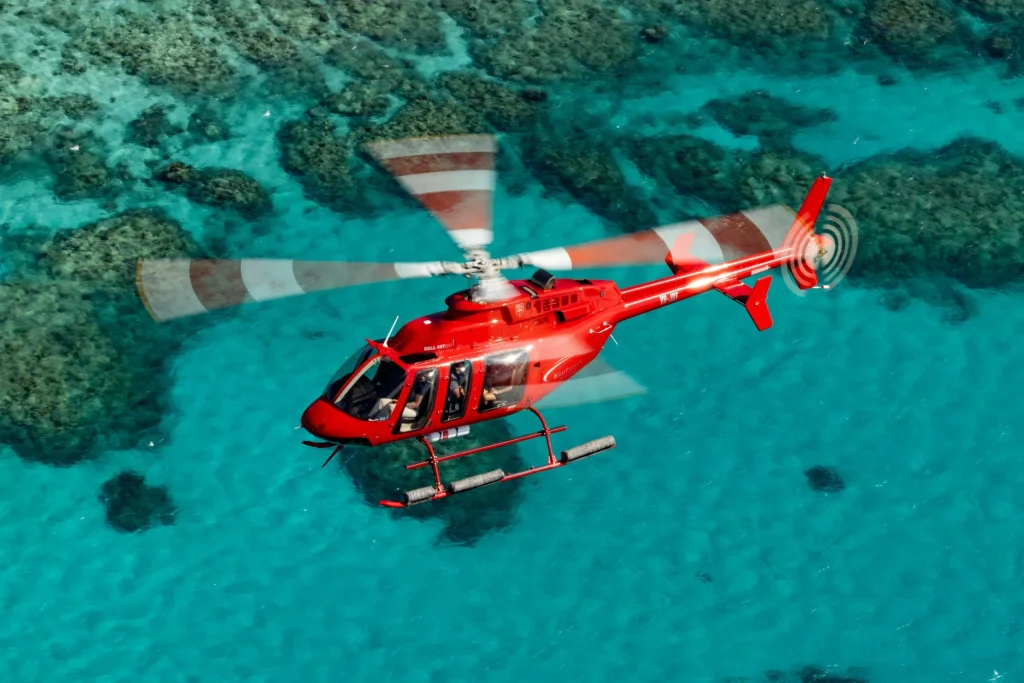 Scenic helicopter flying low over the coral gardens of the Great Barrier Reef